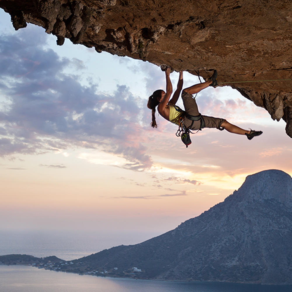Young female rock climber at sunset, Kalymnos Island, Greece